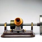 UNITED KINGDOM - NOVEMBER 01: Tinfoil phonograph made by the London Stereoscopic Company. Thomas Edison (1847-1931) invented sound recording in 1877. A sheet of tinfoil, moving under a needle attached to a diaphragm which vibrated in response to sound, became indented with a pattern which could be played back. Edison's first instrument had separate recording and reproducing diaphragms, but the model shown here has a single diaphragm for both functions. Also shown is the flywheel added by Edison to smooth out variations in speed inevitable with hand-turned machines. (Photo by SSPL/Getty Images)